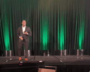 Partnerships Director Shannon Rochon speaking on stage. 
